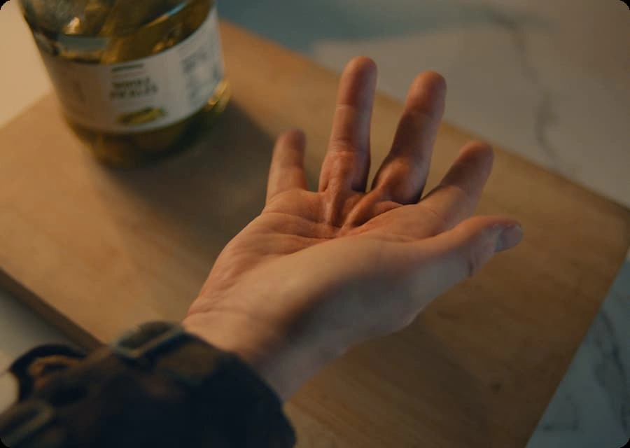 Open hand above wooden tabletop